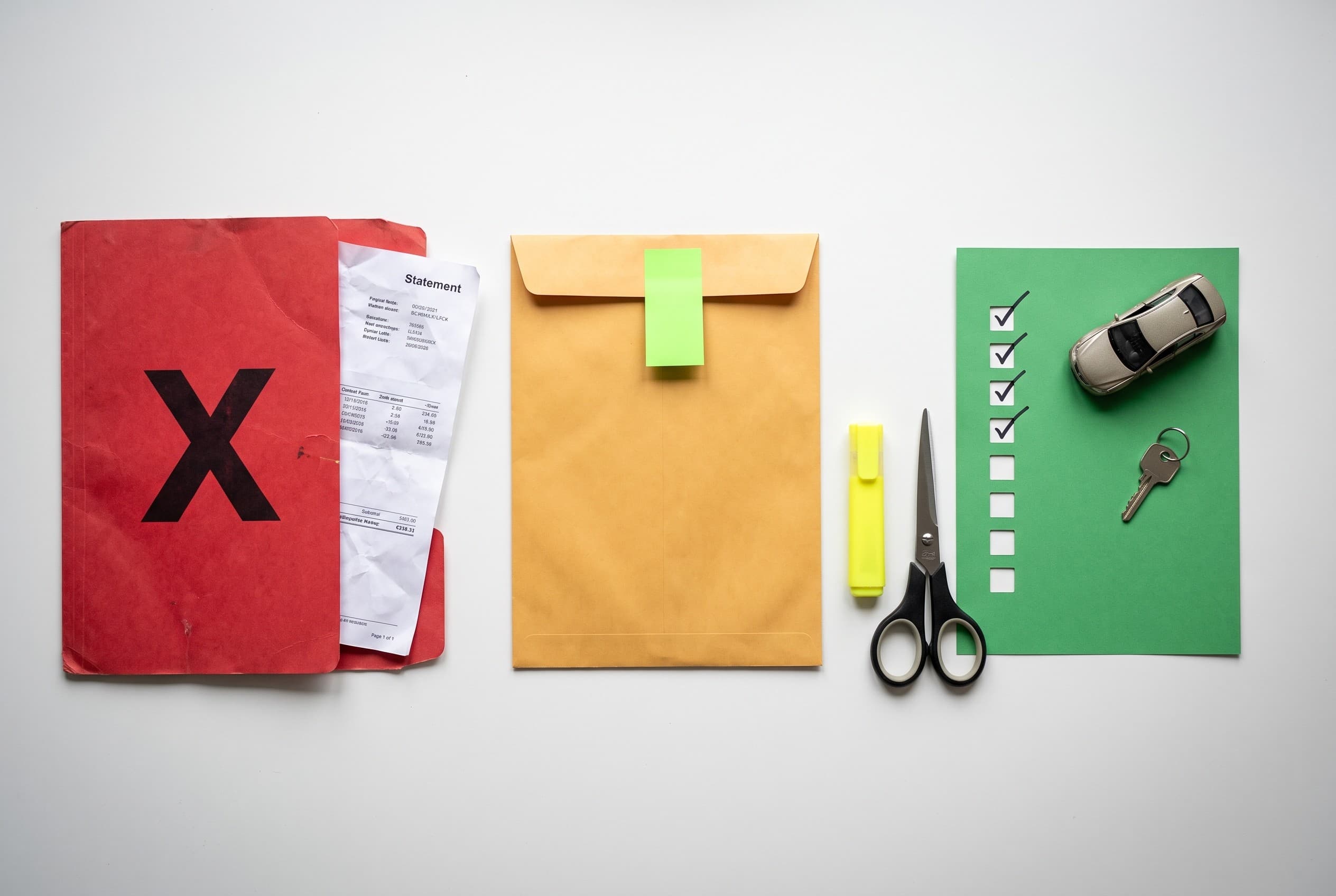 Top-down flat-lay photo on a clean white desk of an adverse-action denial concept. On the left, a red folder stamped with a l