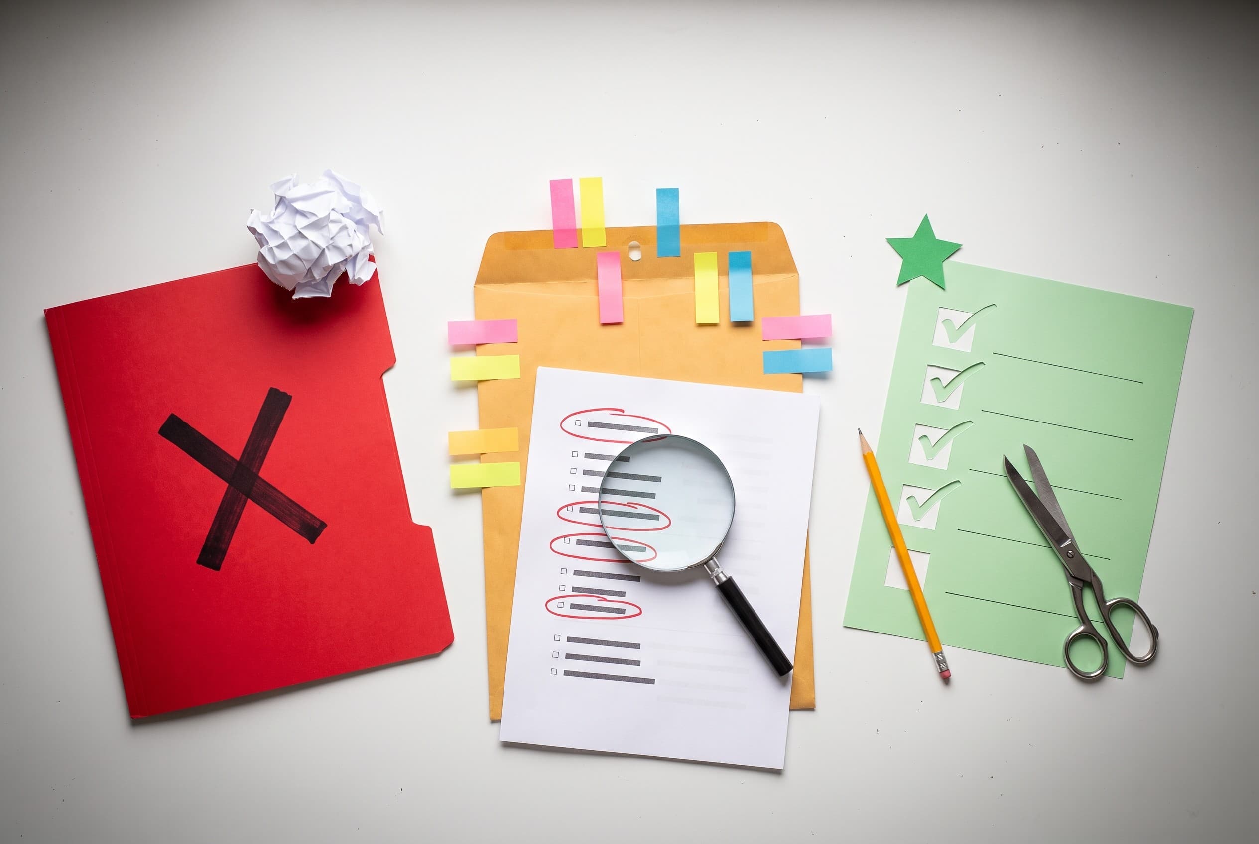 Top-down flat-lay photo on a clean white desk showing the loan-denial fight plan. On the left, a red folder stamped with a bo